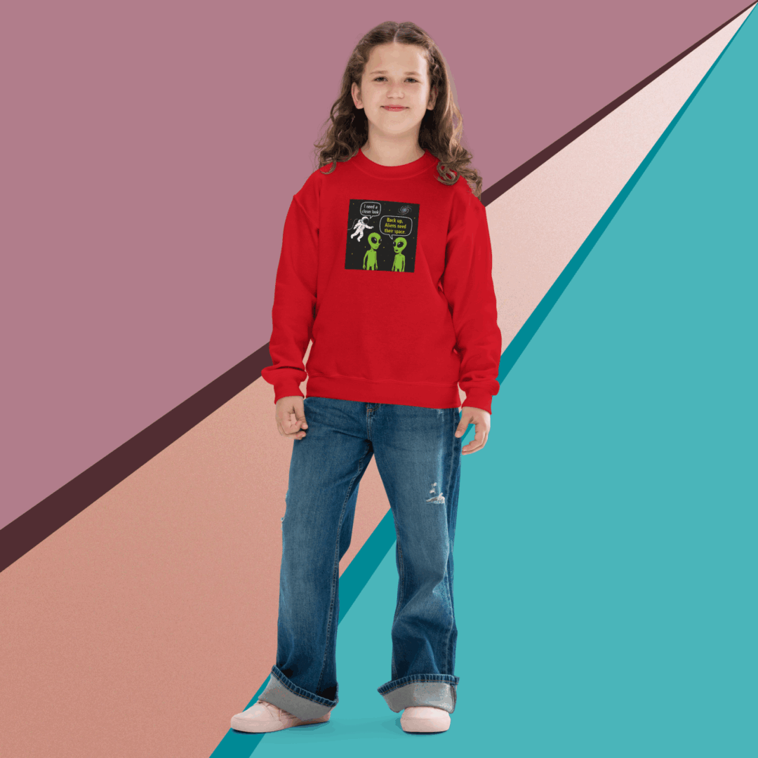A girl in a red sweater and blue jeans stands against a colorful geometric background.