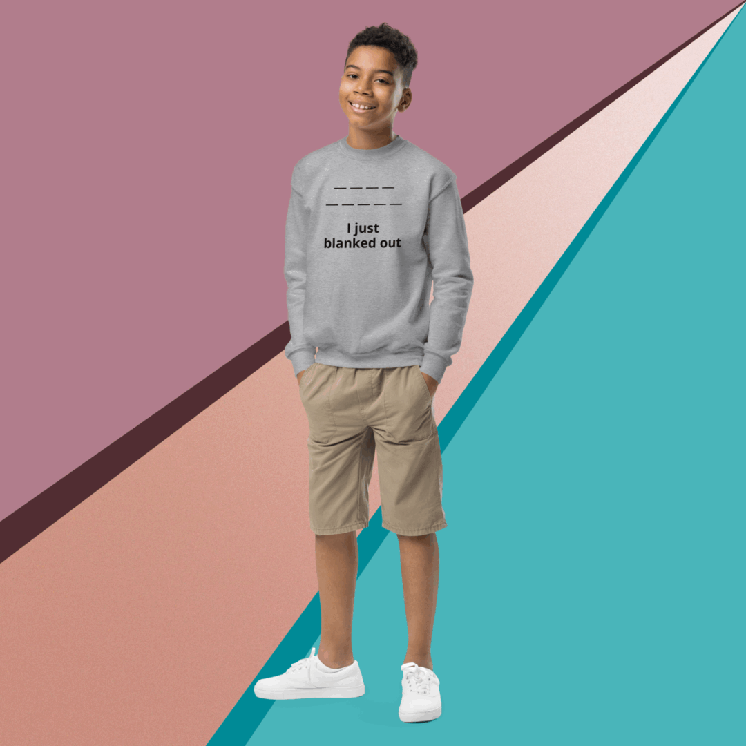 Young man in casual clothes standing against a colorful geometric background.