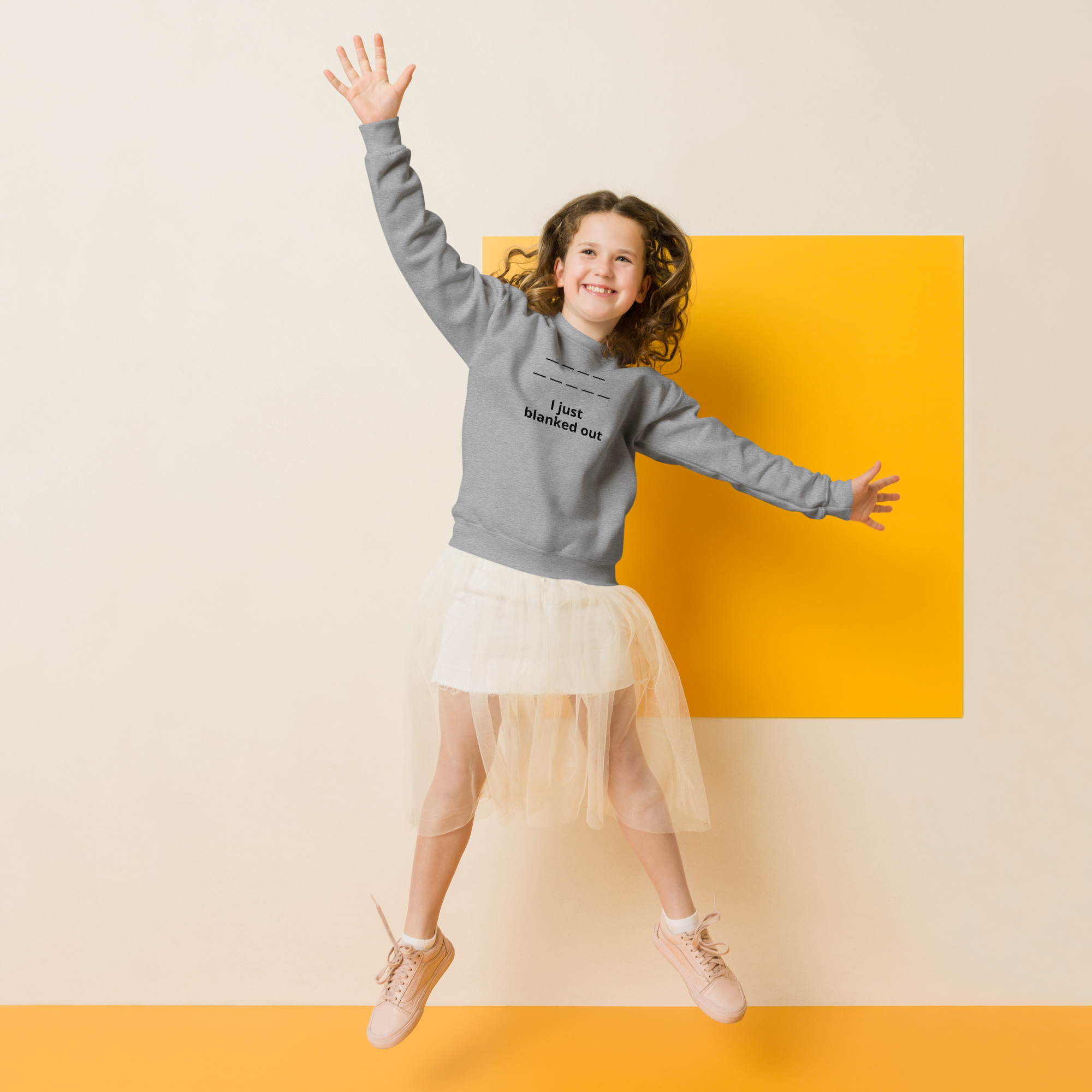 Joyful girl jumping in a light outfit against a bright yellow square.