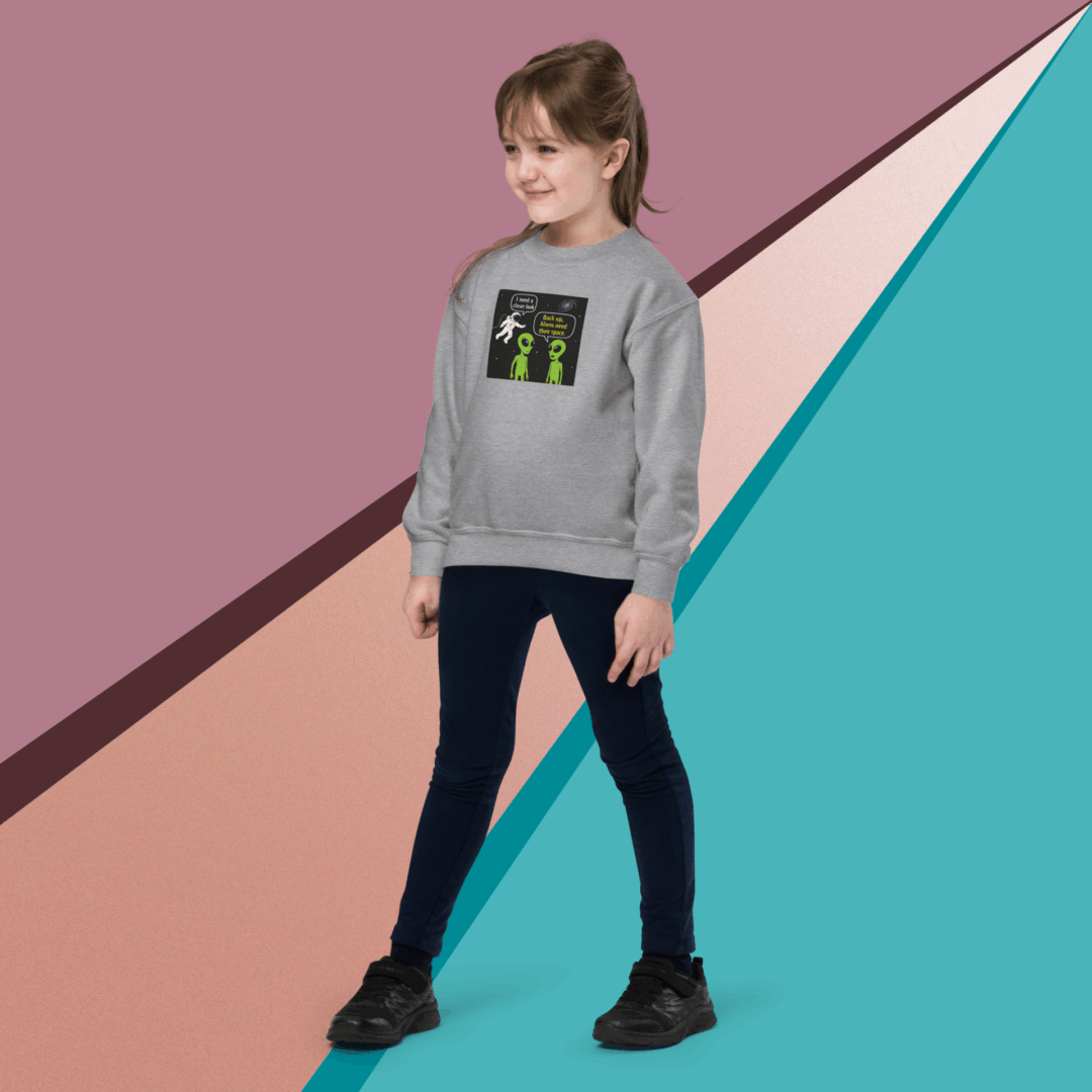 Young woman in casual outfit posing against colorful geometric background.