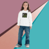 A young girl stands confidently against a colorful geometric background.