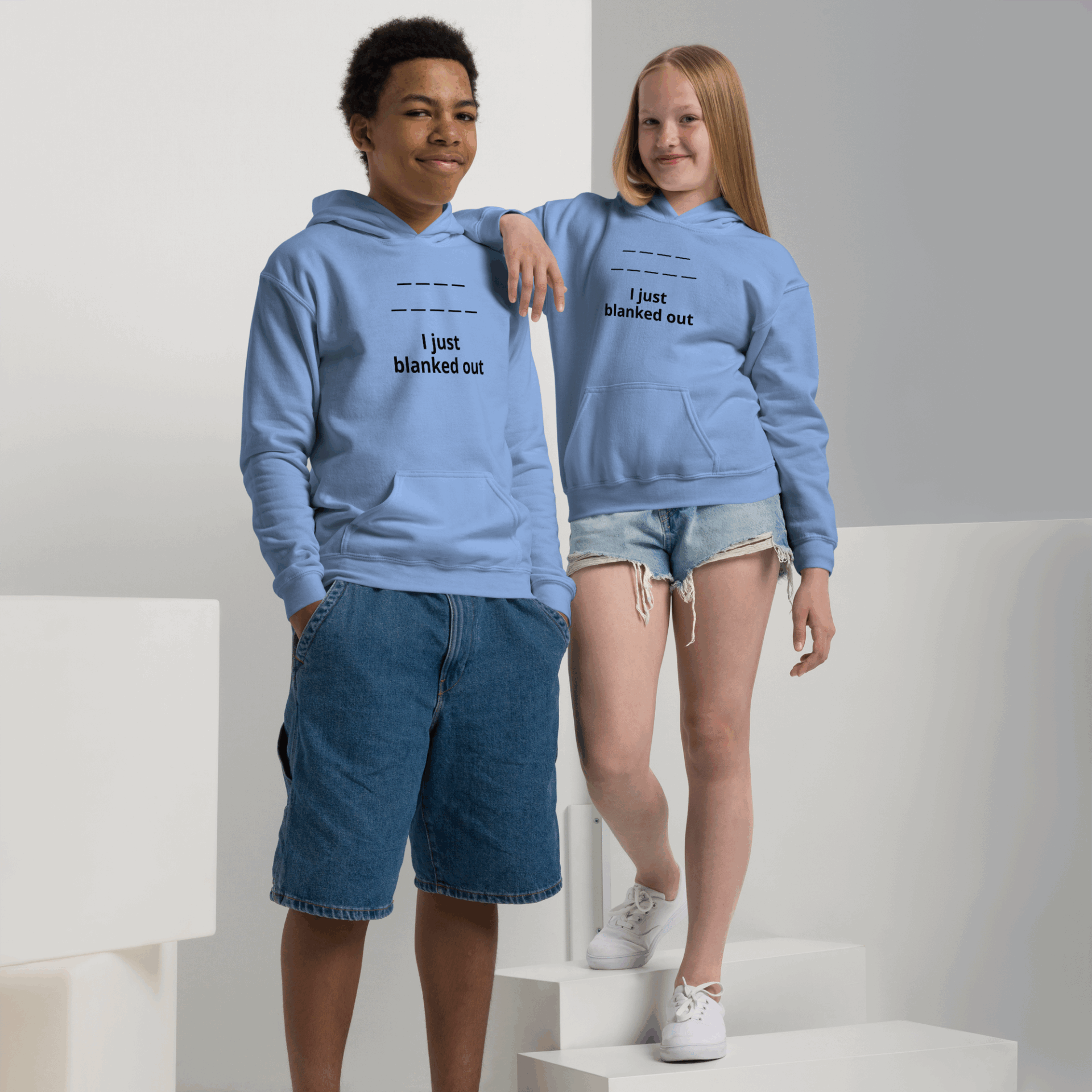 Two teenagers wearing light blue hoodies with the phrase 'I just blanked out'.