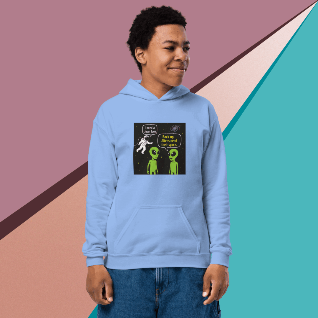 Person wearing a light blue hoodie with a colorful graphic design on the front.