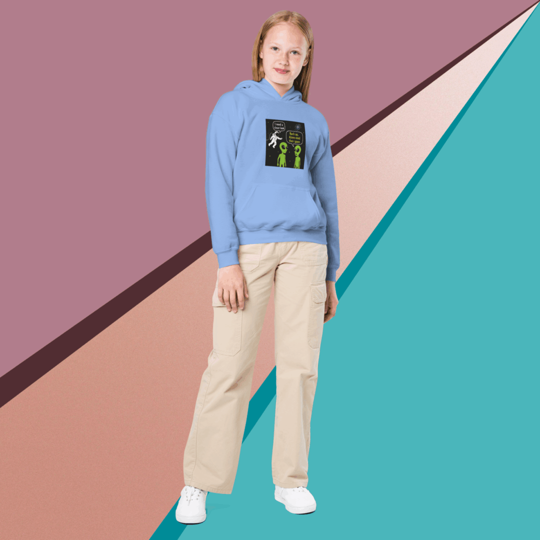 Young woman in casual attire posing against a colorful geometric background.