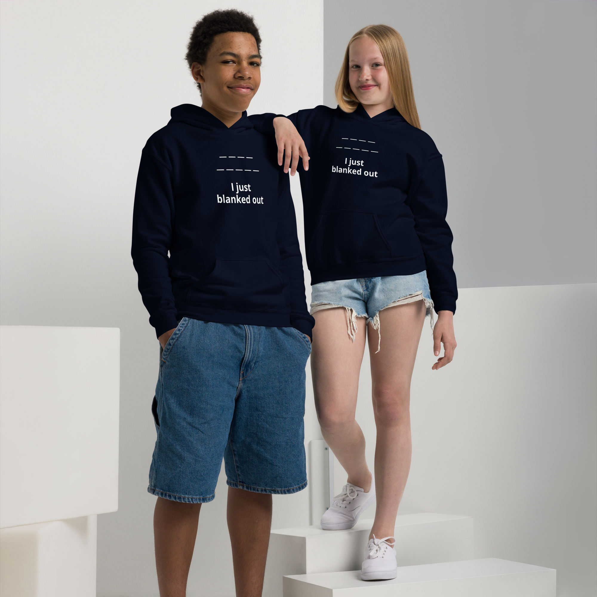 Two teenagers wearing navy hoodies with "I just blanked out" text.