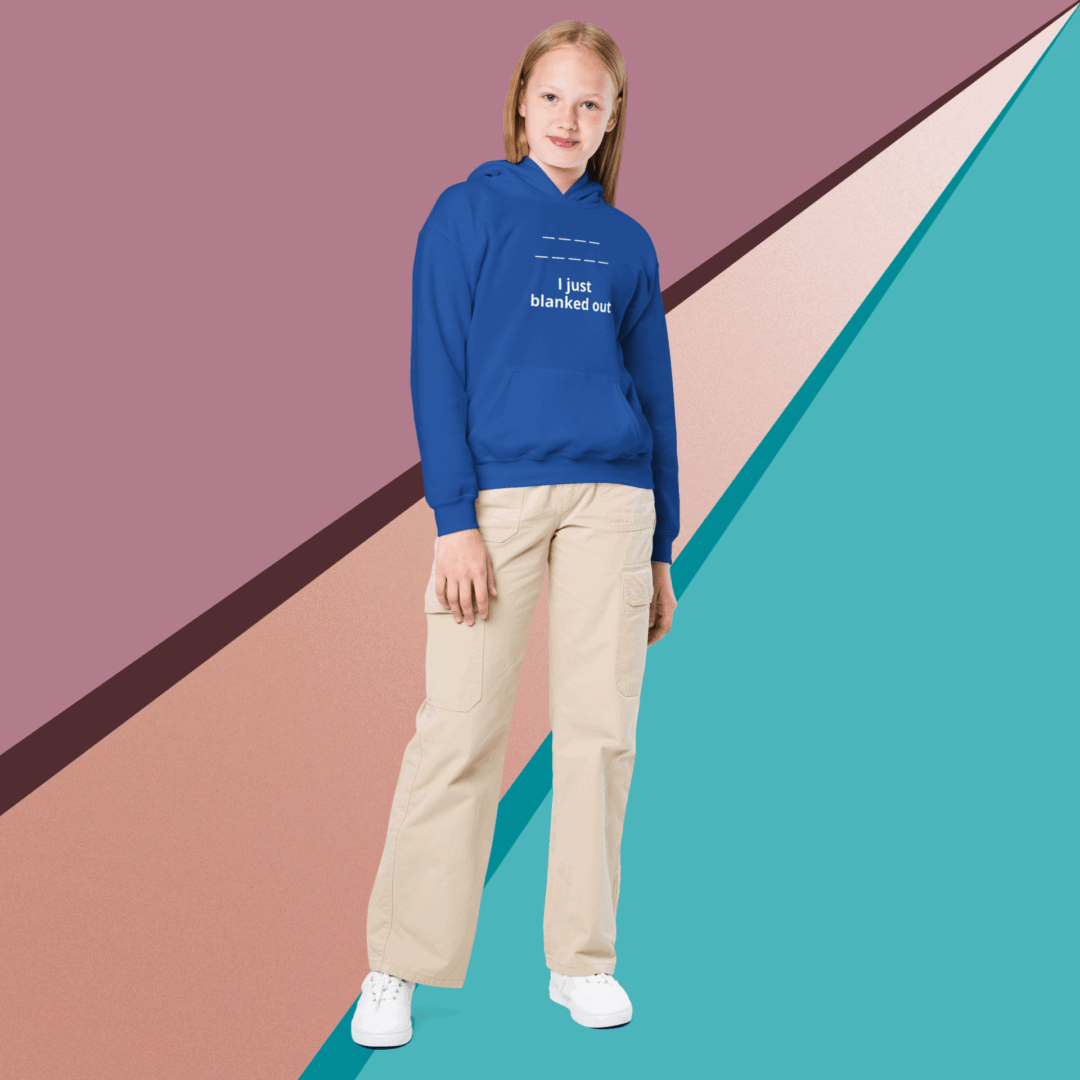 Woman in blue hoodie and beige pants against colorful geometric background.