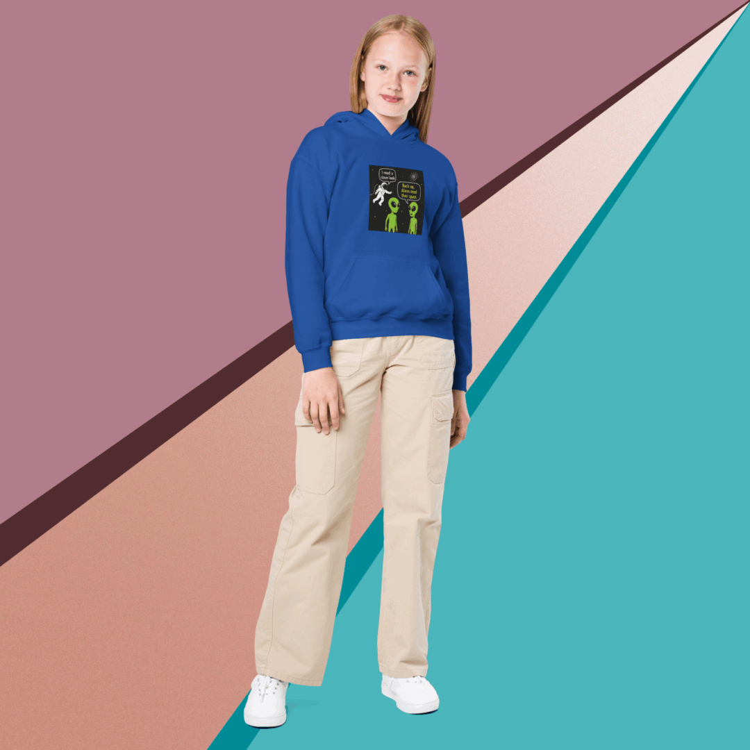 Person in a blue hoodie and beige pants against a colorful geometric background.
