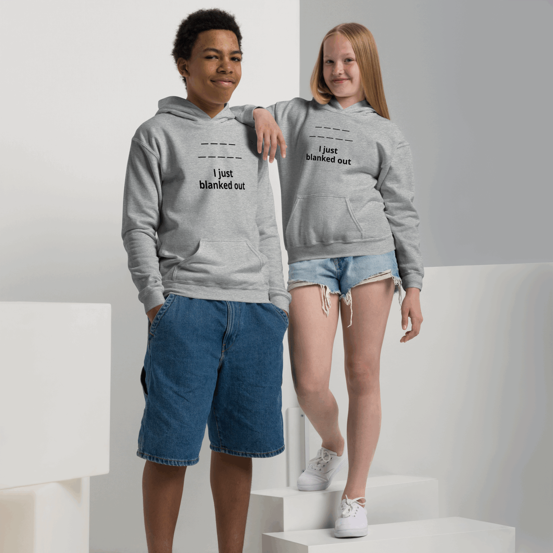 Two kids wearing matching gray hoodies with "I just blanked out" text.