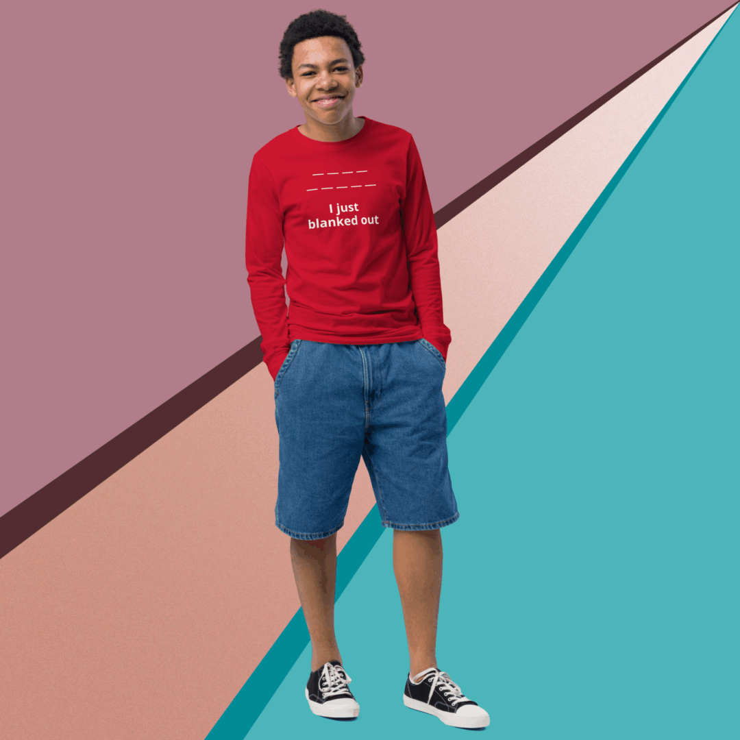 A smiling man in a red sweatshirt and blue shorts against a colorful geometric background.