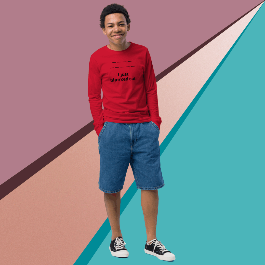 Smiling man in red sweater and blue shorts against colorful geometric background.